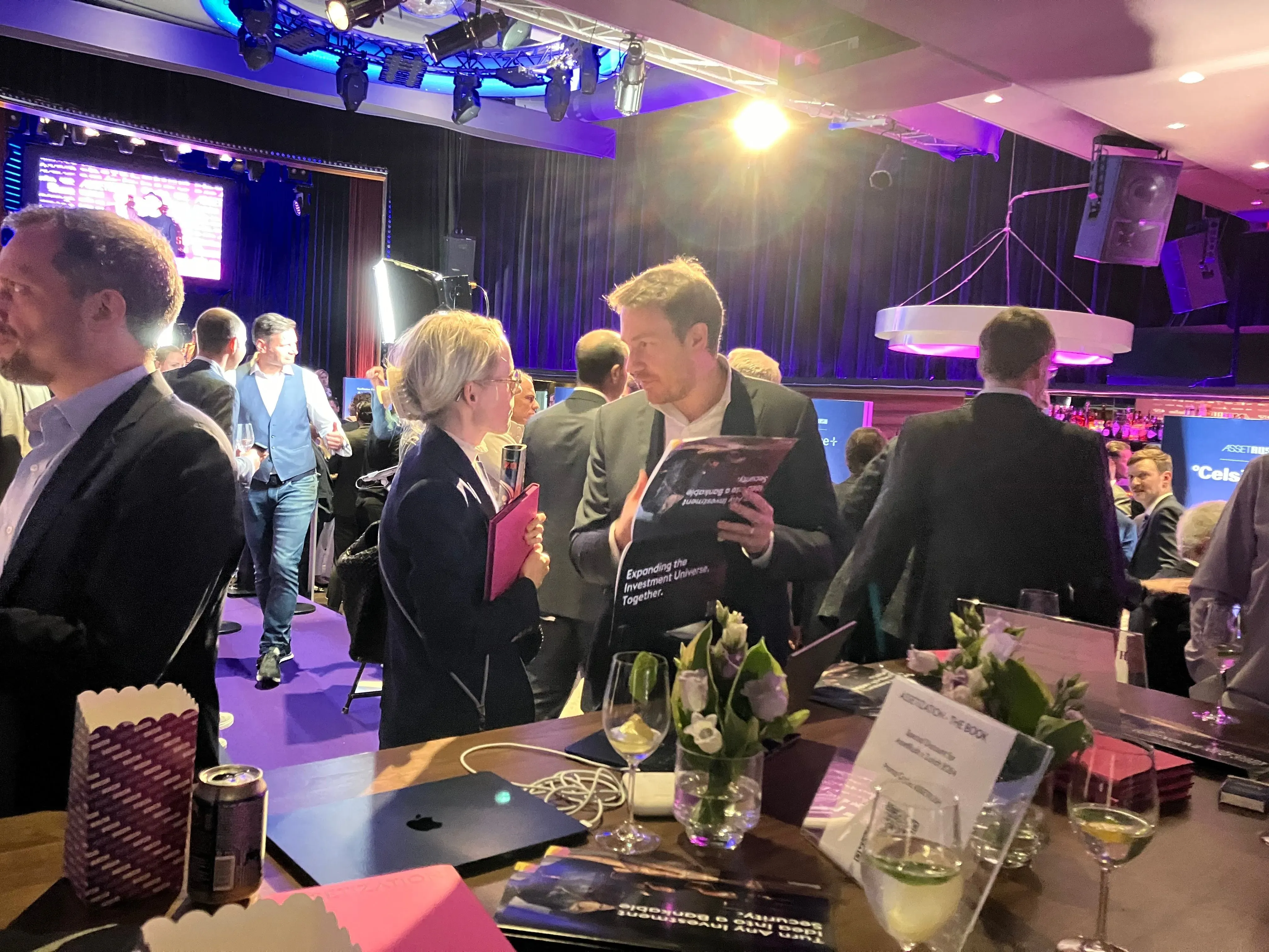 Guests at the AssetRush venue with copies of the Assetization book on the table